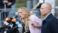 Lawyer Michael Avenatti looks on as Stephanie Clifford also known as Stormy Daniels speaks outside US Federal Court in Lower Manhattan on April 16, 2018. AFP / Eduardo Munoz Alvarez