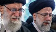 An image grab from an Iran Press video shows Iranian Supreme Leader Ayatollah Ali Khamenei (L) weeping as he recites a prayer in front of the coffin of slain Iranian military commander Qasem Soleimani duing a funeral procession in the capital Tehran on Ja
