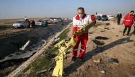 Rescueeams recover debris from a field after a Ukrainian plane carrying 176 passengers crashed near Imam Khomeini airport in the Iranian capital Tehran early in the morning on January 8, 2020, killing everyone on board.  AFP 