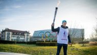  Olympics - 2020 Winter Youth Olympics - Lausanne, Switzerland - January 8, 2020 Nathanael Pianta poses with the Lausanne 2020 Youth Olympic Flame alongside the Olympic Rings outside Olympic House during the the final Torch Relay Joel Marklund for OIS/IOC