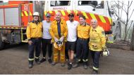 Australia cricketers Tim Paine and Nathan Lyon pose with firefighters as they visit areas affected by bushfires in Southern Highlands, New South Wales, Australia, January 8, 2020 in this still image obtained from social media video. CRICKET AUSTRALIA/via 