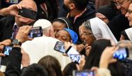 Pope Francis kisses a nun who had been shouting 