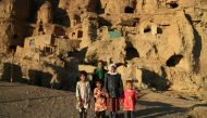 Hazara children in front of caves where they live with their family in Bamiyan on November 17, 2019. AFP / Mohammad Ali Shaida