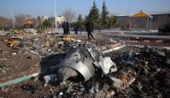 (FILES) In this file photo taken on January 8, 2020 rescue teams work amidst debris after a Ukrainian plane carrying 176 passengers crashed near Imam Khomeini airport in the Iranian capital Tehran early in the morning on January 8, killing everyone on boa