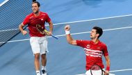 Viktor Troicki (L) and Novak Djokovic (R) of Serbia celebrate winning the first set in their men's doubles match against Pablo Carreno Busta and Feliciano Lopez of Spain in the final of the ATP Cup tennis tournament in Sydney on January 13, 2020.  AFP / W