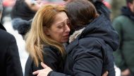 A woman sheds a tear during a memorial service at the University of Toronto in Toronto, Ontario on January 12, 2020 for the victims of Ukrainian Airlines flight 752 which was shot down over Iran this past week. AFP / Geoff Robins