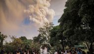 People attend a wedding ceremony as Taal Volcano sends out a column of ash in the background in Alfonso, Cavite, Philippines, January 12, 2020, in this image obtained from social media. Courtesy of Randolf Evan Photography/Social Media via REUTERS