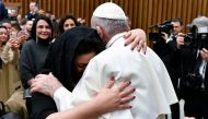 Pope Francis hugs a woman during the weekly general audience at the Vatican, January 15, 2020. Vatican Media handout via Reuters