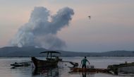 A fisherman catches fish as the Taal Volcano continuously errupts in Talisay, Batangas, Philippines, January 16, 2020. REUTERS/Eloisa Lopez