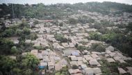 A bird's eye view of mud-covered and destroyed houses with Taal volcano in background as seen from a Philippine airforce helicopter during an aerial survey in Agoncillo town, Batangas province, south of Manila on January 21, 2020. / AFP / Ted ALJIBE 