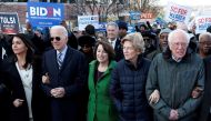 FILE PHOTO: Tulsi Gabbard, Joe Biden, Amy Klobuchar, Elizabeth Warren and Bernie Sanders, walk arm-in-arm with during the MLK Day Parade in Columbia, January 20, 2020. Reuters / Randall Hill