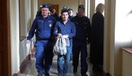 In this file photo taken on March 5, 2019 Football Leaks whistleblower Rui Pinto (C) is escorted by judicial officers as he arrives at the Metropolitan Court in Budapest, Hungary, for his trial. / AFP / FERENC ISZA