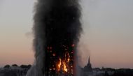 FILE PHOTO: Flames and smoke billow as firefighters deal with a serious fire in the Grenfell Tower apartment block at Latimer Road in West London, Britain June 14, 2017. REUTERS/Toby Melville/File Photo