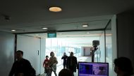 Officials monitor thermal scanners as passengers walk past upon arrival of a flight from Hangzhou, China at Changi Airport, Singapore January 22, 2020. REUTERS/Yiming Woo
