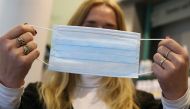 An employee shows a protective face mask on January 28, 2020 at a pharmacy in Kaufbeuren, southern Germany. - Germany OUT / AFP / dpa / Karl-Josef Hildenbrand
 