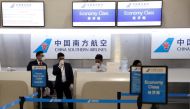 China Southern Airlines employees wear a surgical mask as a preventive measure in light of the coronavirus outbreak in China, as they wait for customers behind the counter at Benito Juarez international airport in Mexico City, Mexico January 28, 2020. REU