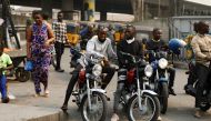  Motorcycle taxi drivers sit on their bikes, popularly called 