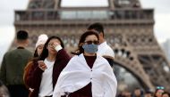 A woman wears a protective mask in light of the coronavirus outbreak in China as she walks at the Trocadero esplanade in front of the Eiffel Tower in Paris, France, February 1, 2020. REUTERS/Gonzalo Fuentes