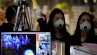 Passengers wearing masks to prevent contracting coronavirus walk past a thermal camera upon their arrival at Incheon International Airport in Incheon, South Korea, January 3, 2020. REUTERS/Kim Hong-Ji