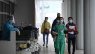 Medical staff are seen outside Princess Margaret Hospital in Hong Kong on February 4, 2020. AFP / Anthony Wallace 