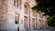 A woman walks in front of the government headquarters at the Republic square in Yerevan, Armenia, May 3, 2018. Reuters/David Mdzinarishvili