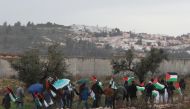 Palestinian demonstrators gather at the separation wall during a protest against US President Donald Trump’s Middle East plan near at Bil'in town in Ramallah, West Bank on February 07, 2020. (Issam Rimawi / Anadolu Agency)
 