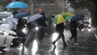 Pedestrians hold umbrellas during wet weather in Sydney, Australia, February 7, 2020. AAP Image/Peter Rae/via REUTERS