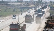 A Turkish military convoy of tanks and armoured vehicles passes near the city of Idlib, in northwestern Syria, near the Syria-Turkey border, on February 8, 2020. / AFP / Omar HAJ KADOUR