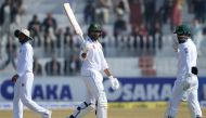 Pakistan's Haris Sohail (C) celebrates after scoring a half century (50 runs) as Bangladesh's wicketkeeper Liton Das (R) looks on during the third day of the first cricket Test match between Pakistan and Bangladesh at the Rawalpindi Cricket Stadium in Raw