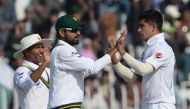 Pakistan's bowler Naseem Shah (R) celebrates with teammates Babar Azam (C) and Asad Shafiq after the dismissal of Bangladesh's Saif Hassan (unseen) during the third day of the first cricket Test match between Pakistan and Bangladesh at the Rawalpindi Cric