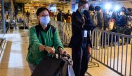 Passengers leave the World Dream cruise ship at the Kai Tak terminal in Hong Kong on February 9, 2020, where 3,600 people confined aboard for days as coronavirus checks was going. AFP / Philip Fong 