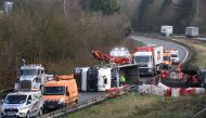 Rescuers work on the A2 motorway in Marly, northern France, after a truck was tipped over in the early morning from strong winds brought by storm Ciara on February 10, 2020. AFP / FRANCOIS LO PRESTI
