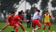 This photograph taken on January 13, 2020, shows former French football player and technical director of the Promotion Fund of Vietnamese Football Talent (PVF) academy Philippe Troussier (C) watching players during a training session at the PVF academy in