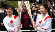 Acting torchbearer and Actress Satomi Ishihara (R), one of the Official Ambassadors of the Tokyo 2020 Torch Relay pose with the olympic torch during a rehearsal as part of the Tokyo 2020 Olympic Torch Relay in Hamura, outskirts of Tokyo, Japan February 15