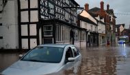 Flood water surrounds abandoned cars left in a flooded street in Tenbury Wells, after the River Teme burst its banks in western England, on February 16, 2020, after Storm Dennis caused flooding across large swathes of Britain. AFP / Oli SCARFF