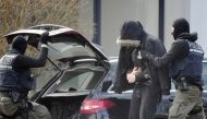 Picture shows police officers bringing a man believed to be one of the twelve men arrested a day earlier in a nationwide probe into an extreme-right at the Federal Supreme Court (Bundesgerichtshof) in Karlsruhe, southern Germany on February 15, 2020. Germ