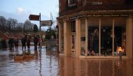 People look at flood water in Market Street in Tenbury Wells, after the River Teme burst its banks in western England, on February 16, 2020. AFP / Oli SCARFF