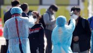  Passengers wearing masks have their body temperatures taken after leaving the coronavirus-hit cruise ship Diamond Princess at Daikoku Pier Cruise Terminal in Yokohama, south of Tokyo, Japan February 21, 2020. REUTERS/Kim Kyung-Hoon 