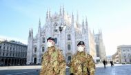 Military officers wearing face masks stand outside Duomo cathedral, closed by authorities due to a coronavirus outbreak, in Milan, Italy February 24, 2020. Reuters/Flavio Lo Scalzo