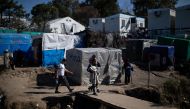 Migrants make their way at a makeshift camp surrounding the Moria migrant camp on the island of Lesbos, Greece, February 18, 2020.  Reuters/Alkis Konstantinidis