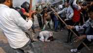 People supporting the new citizenship law beat a Muslim man during a clash with those opposing the law in New Delhi, India, February 24, 2020. Reuters/Danish Siddiqui