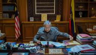 This handout photo taken and released on February 25, 2020 by the Prime Minister's Office of Malaysia shows interim prime minister Mahathir Mohamad working in his office in Putrajaya. AFP PHOTO / Prime Minister's Office of Malaysia / Khairul Ariffin
