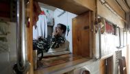 Simon Wong at his 2 square metre subdivided residential unit, known as a 