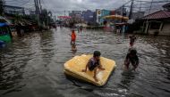 Children play in the floodwaters after heavy rains in Bekasi, near Jakarta, Indonesia February 25, 2020 in this photo taken by Antara Foto. Antara Foto/Yulius Satria Wijaya/ via REUTERS