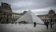 In this file photo taken on February 28, 2020 people visit the Louvre Pyramide in Paris.  AFP / Stephane De Sakutin 
 