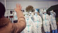 Medical staff members wave to a recovered patient (foreground L) at Leishenshan Hospital, the makeshift hospital for the COVID-19 coronavirus patients, in Wuhan in China's central Hubei province on March 1, 2020. / AFP / STR 
