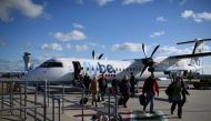 In this file photo taken on November 08, 2017 Passengers dissembark from a flybe aircraft after landing at Jersey Airport in St Peter, north of St Helier, on the British island of Jersey. / AFP / Oli SCARFF
