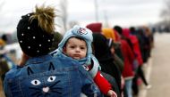 Migrants stand in line to receive food aid at Turkey's Pazarkule border crossing with Greece's Kastanies, near Edirne in Turkey, March 5, 2020. Reuters/Murad Sezer