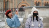Chinese young women are pictured wearing mask in the Red Square in Moscow, Russia January 28, 2020. Reuters/Maxim Shemetov