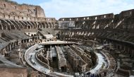 Tourists, some of them wearing respiratory masks, visit the Coliseum in Rome on March 6, 2020.  AFP / Tiziana Fabi 
